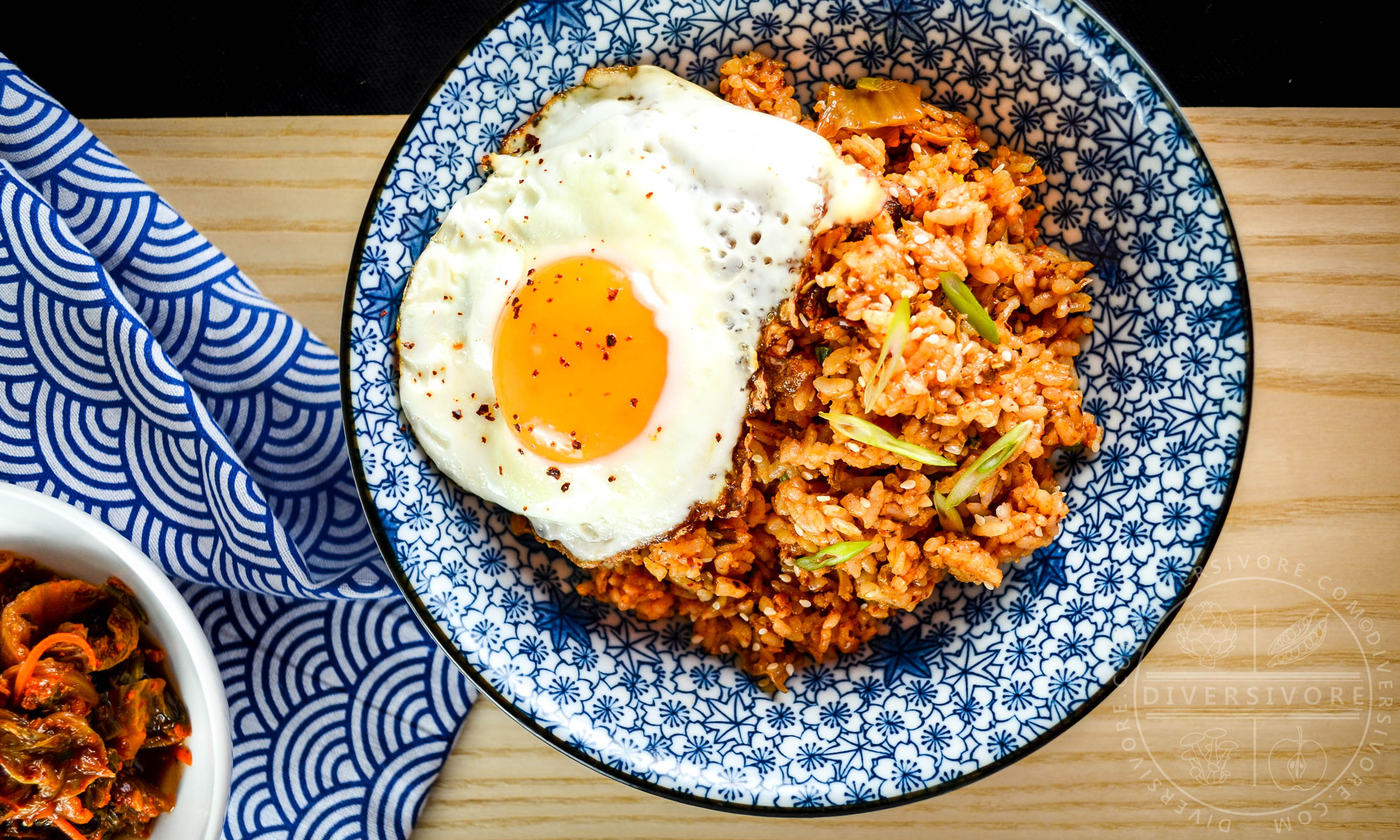 Kimchi fried rice in a blue patterned bowl, topped with a fried egg