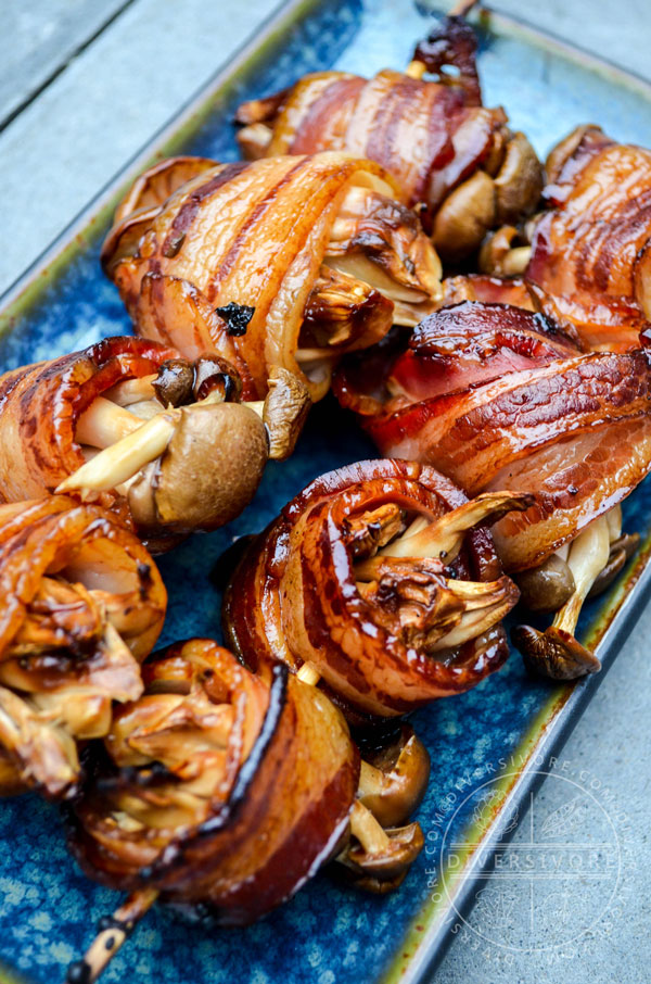 Bacon-wrapped Shimeji Mushroom Kushiyaki (grilled skewers) on a blue plate