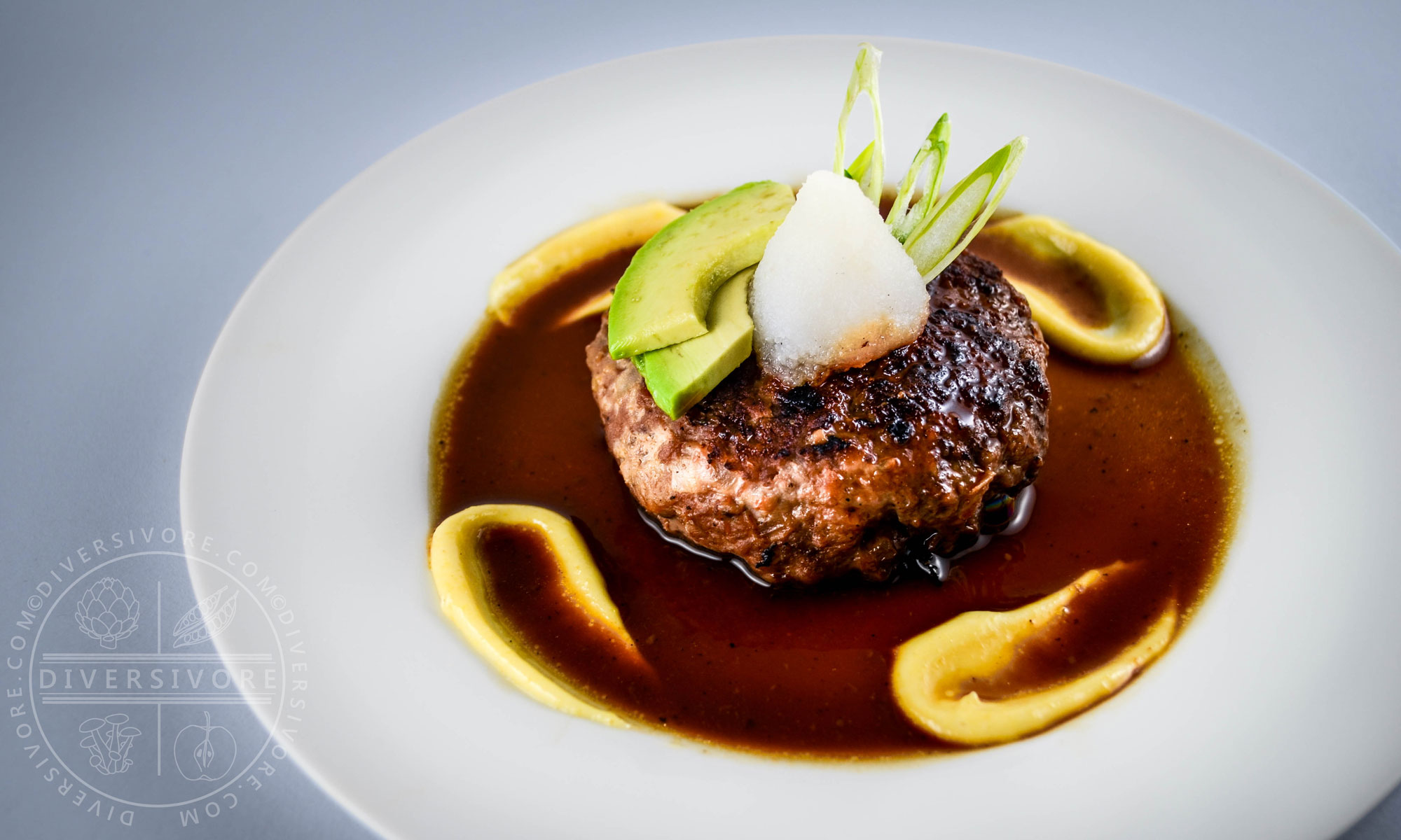 Wafu (Japanese-style) Hamburger on a white plate with karashi mustard/mayo and daikon oroshi