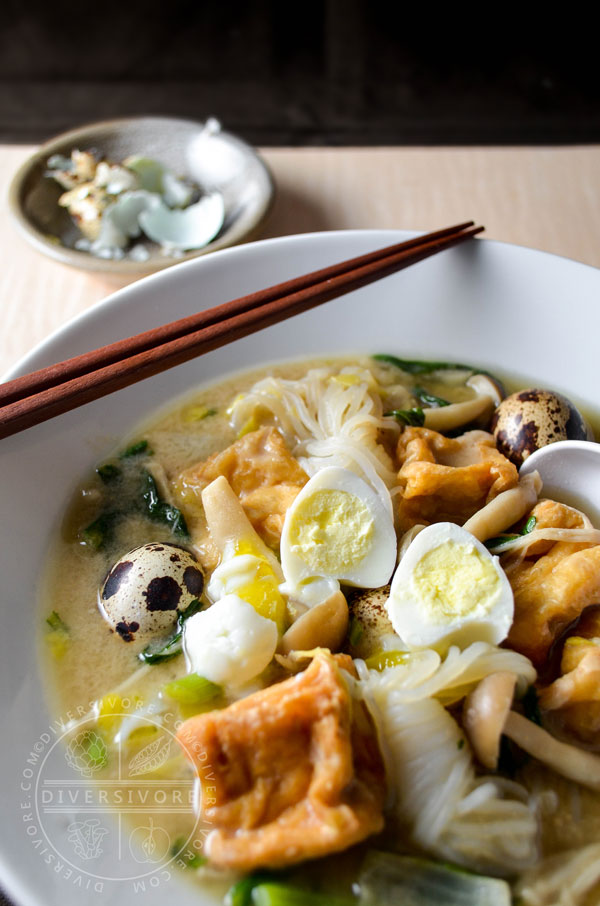 Kitsune Nabe - a Japanese stew or hotpot made with fried tofu, quail eggs, shirataki noodles, shimeji mushrooms, and chrysanthemum greens