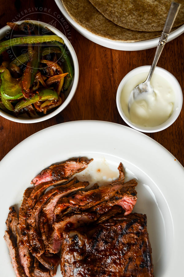 Carne Asada Borracha (Mexican beer-marinated grilled steak) served with Mexican crema and sauteed vegetables.