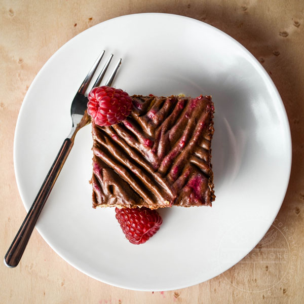 Chocolate Raspberry Rose Icebox Cake slice with a small fork on a white plate