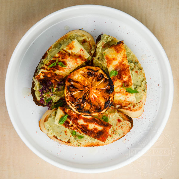 Grilled Halloumi with basil-cannellini hummus, served with grilled lemons and toasted baguette