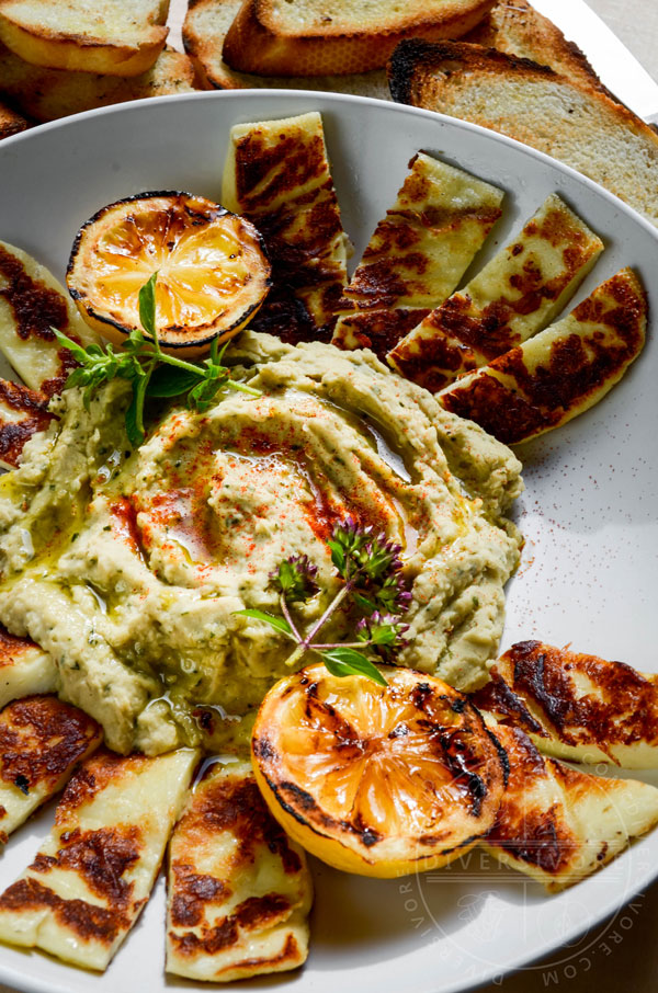 Grilled Halloumi with basil-cannellini hummus, served with grilled lemons and toasted baguette