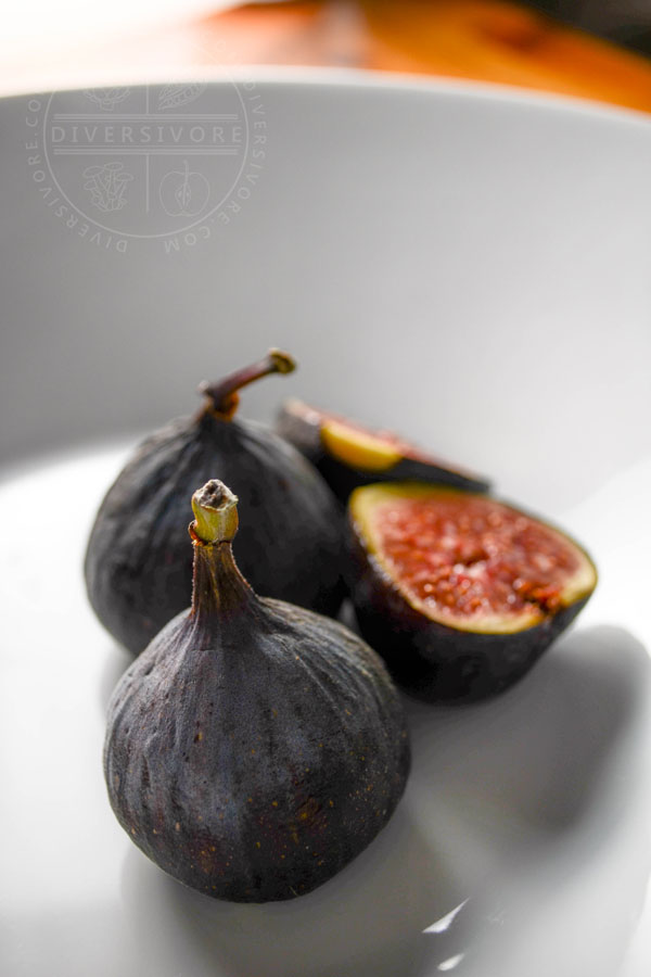 Black mission figs in a white bowl