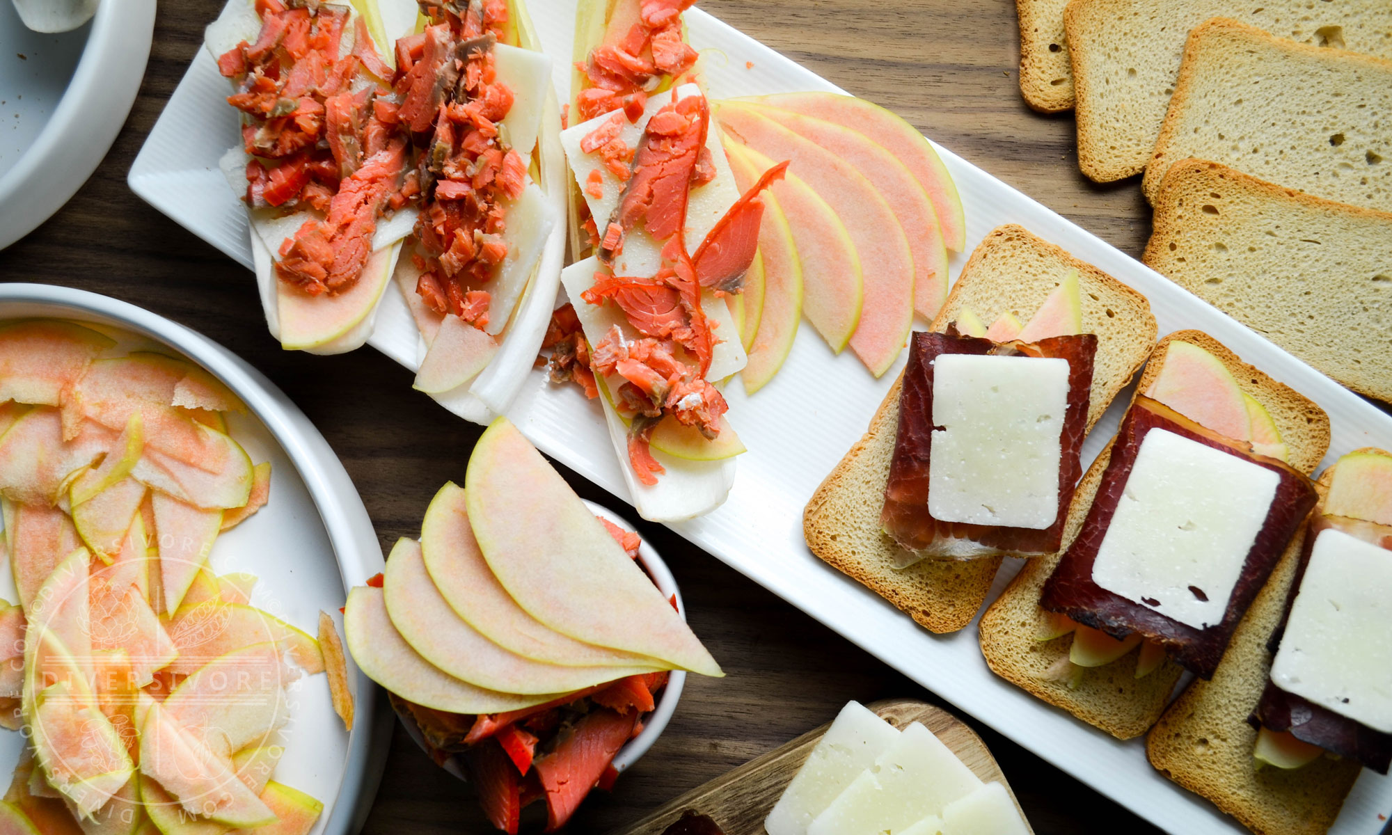 Pink Pearl apples and a charcuterie board with manchego, bison bresaola, smoked salmon, and endive