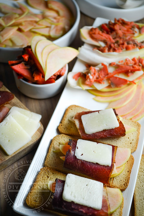 Pink Pearl apples and a charcuterie board with manchego, bison bresaola, smoked salmon, and endive