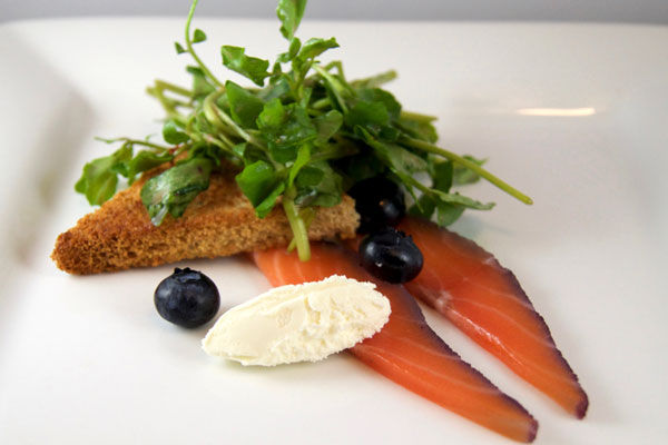Blueberry and gin salmon gravlax with greens and toast