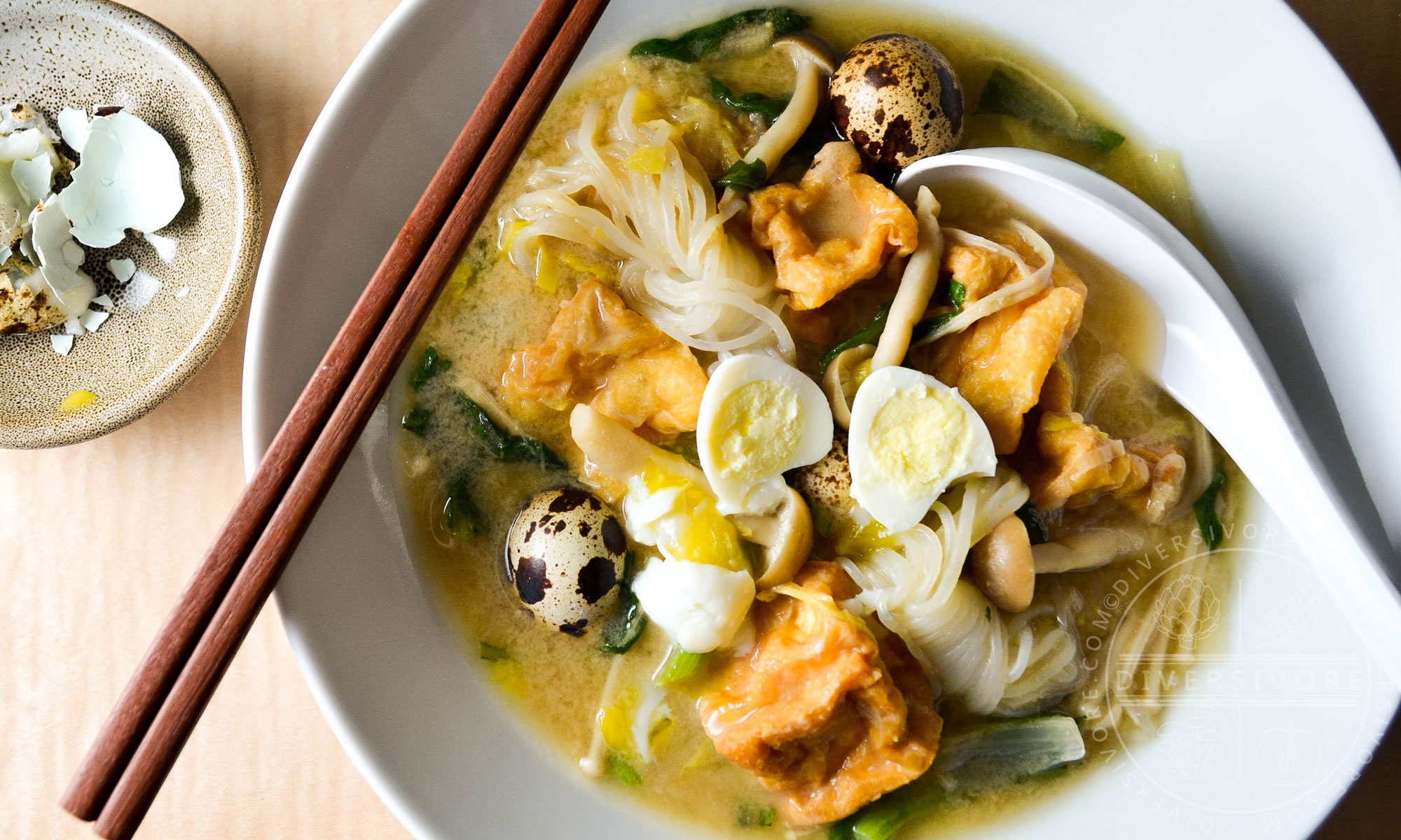 Kitsune Nabe - a Japanese stew or hotpot made with fried tofu, quail eggs, shirataki noodles, shimeji mushrooms, and chrysanthemum greens