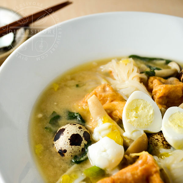 Kitsune Nabe - a Japanese stew or hotpot made with fried tofu, quail eggs, shirataki noodles, shimeji mushrooms, and chrysanthemum greens