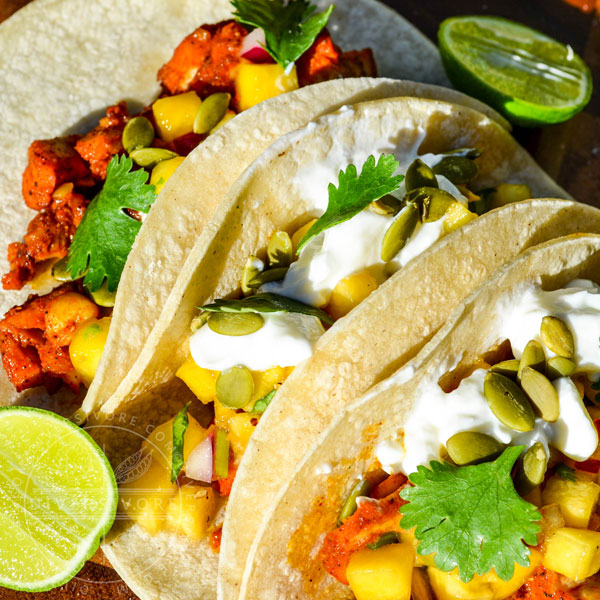 Yucatecan Fish Tacos with peach salsa, sour cream, and pumpkin seeds