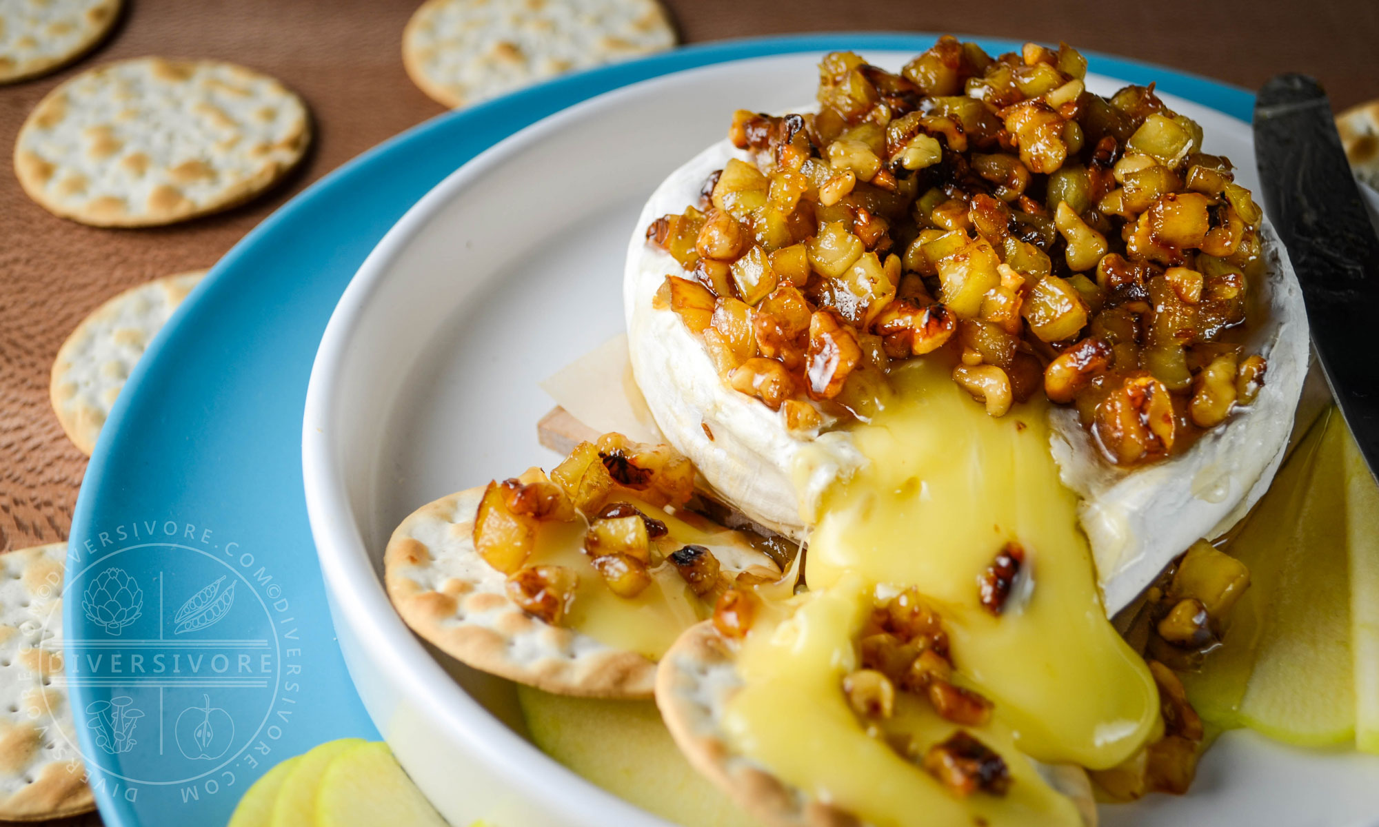 Oozing baked brie, topped with an apple, walnut, and caraway mixture, served with crackers