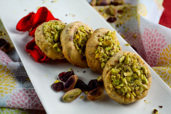 Cranberry shortbread with white chocolate and pistachios on a long white plate
