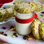 Cranberry shortbread, rolled in white chocolate and crushed pistachios - Diversivore.com