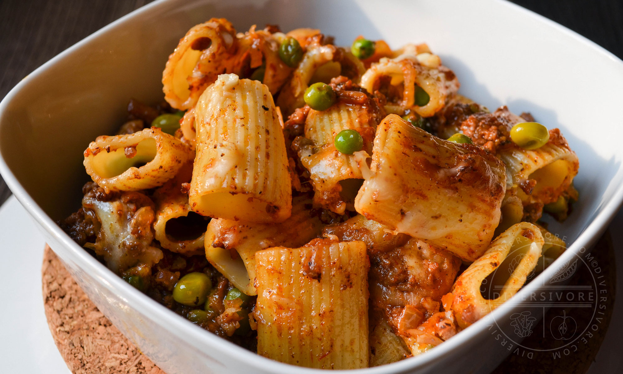 Beef Rigatoni with Caramelized Onions and White Wine, served in a square bowl with rounded edges