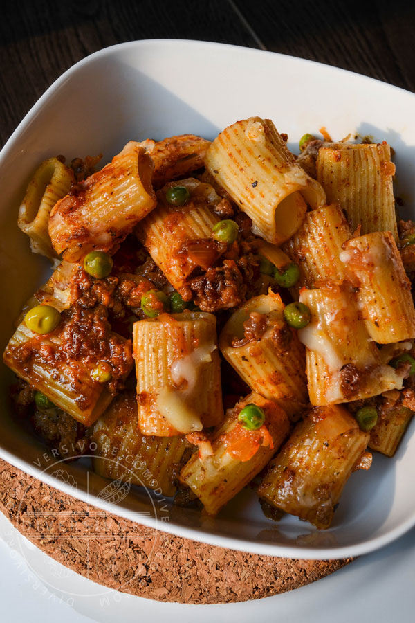 Beef Rigatoni with Caramelized Onions and White Wine, served in a square bowl with rounded edges