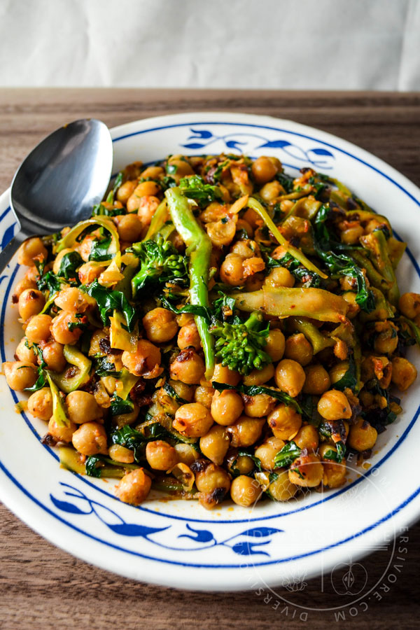 Chickpea and Gai Lan Spaghettini in a blue and white bowl with a spoon