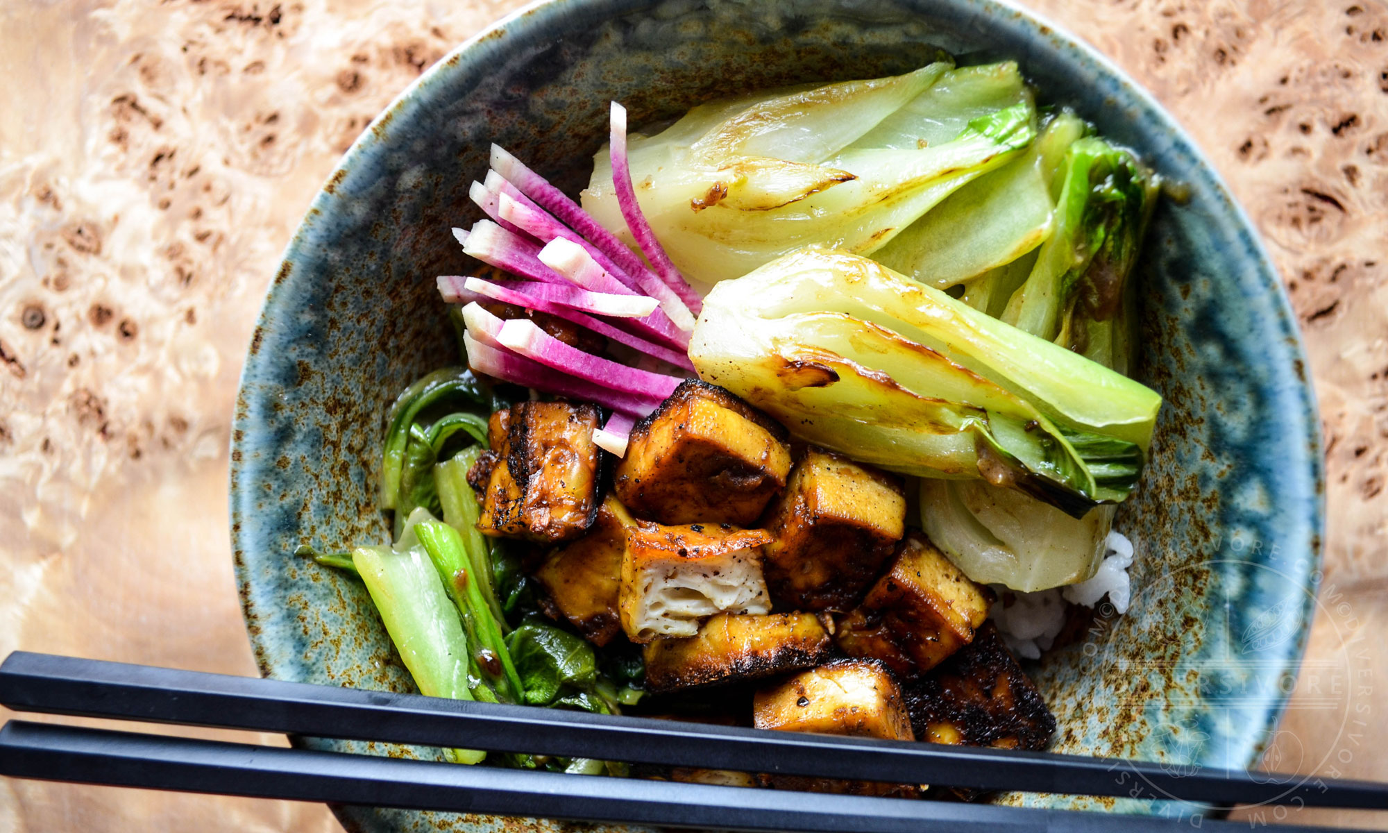 Five-spice crispy seared tofu with bok choy and watermelon radish in a large rice bowl