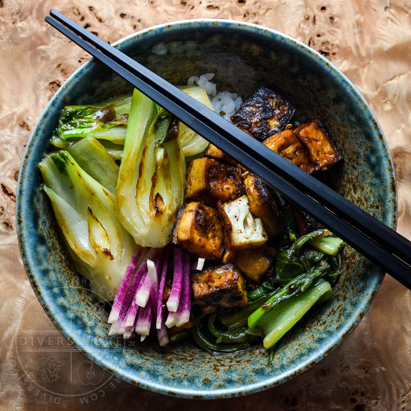 Five-spice crispy seared tofu with bok choy and watermelon radish in a large rice bowl