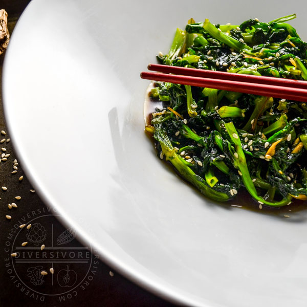 Honey and Ginger Pea Tips with chopsticks in a large white bowl
