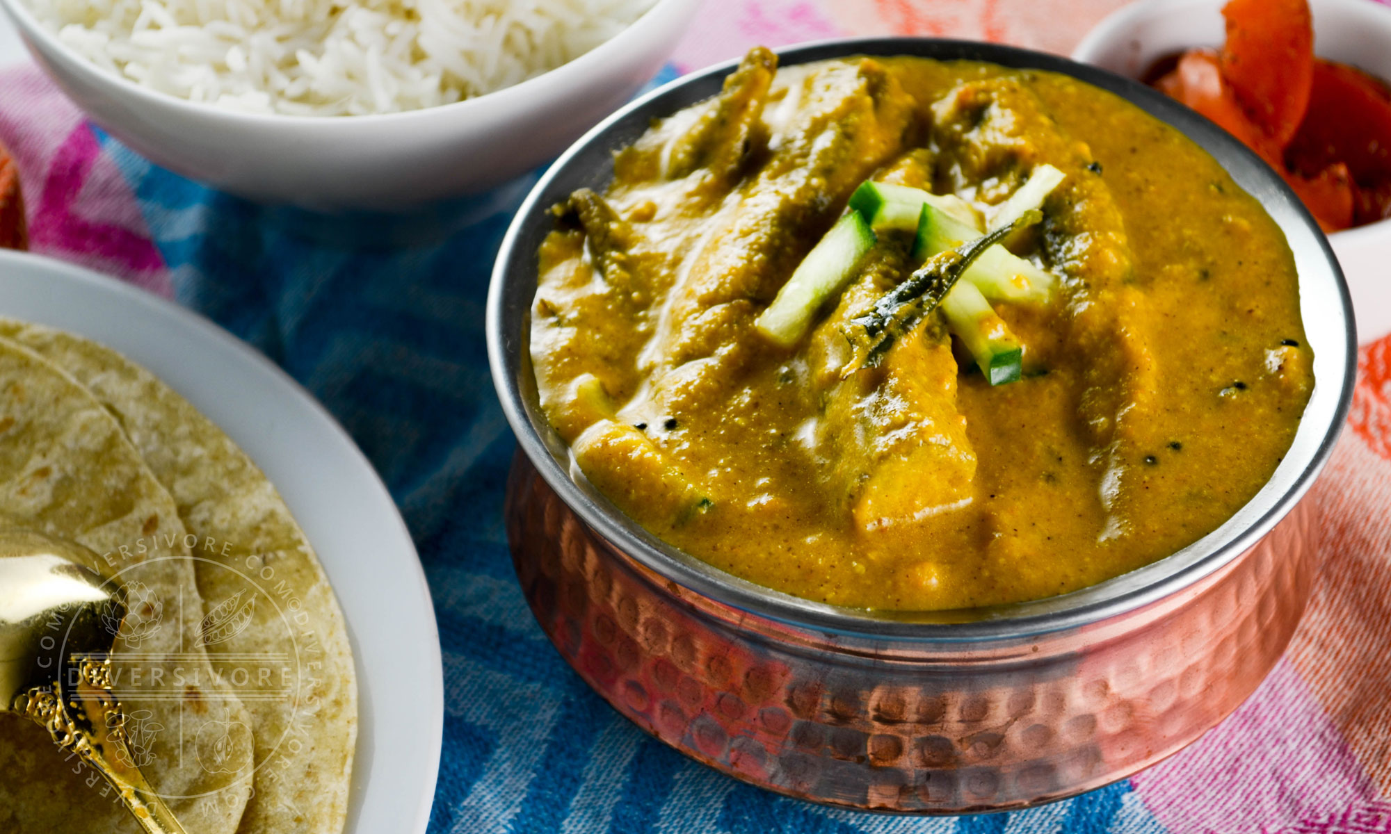 Roasted Okra Kuzhambu (South Indian Curry) in a copper serving dish