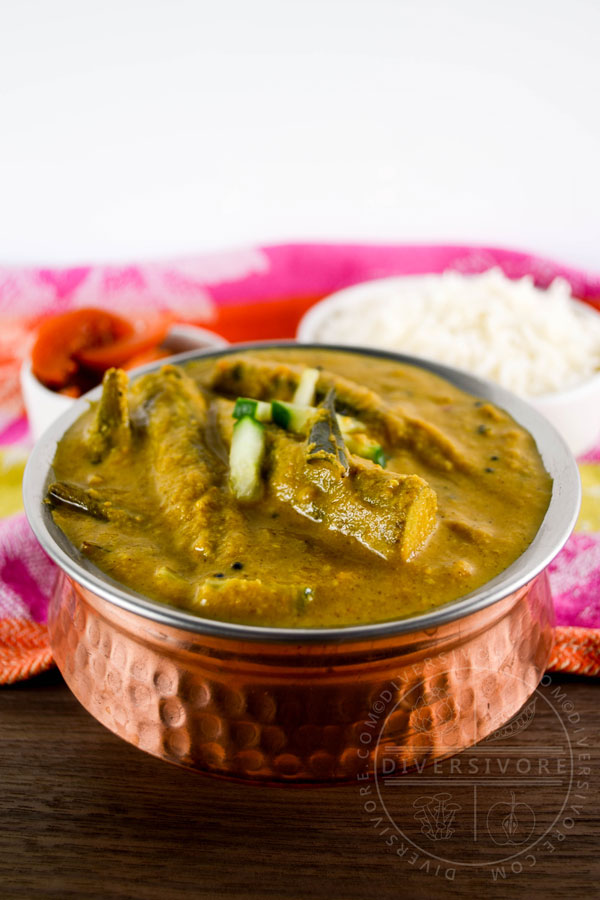 Roasted Okra Kuzhambu (South Indian Curry) in a copper serving dish