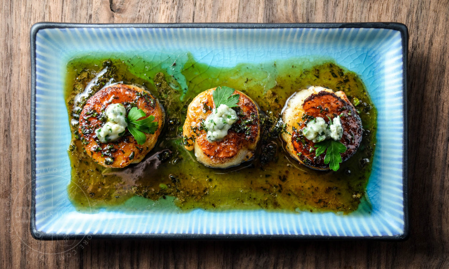 Seared scallops with a honey-parsley gastrique and topped with blue cheese - Diversivore.com