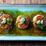 Seared scallops with a honey-parsley gastrique and topped with blue cheese - Diversivore.com