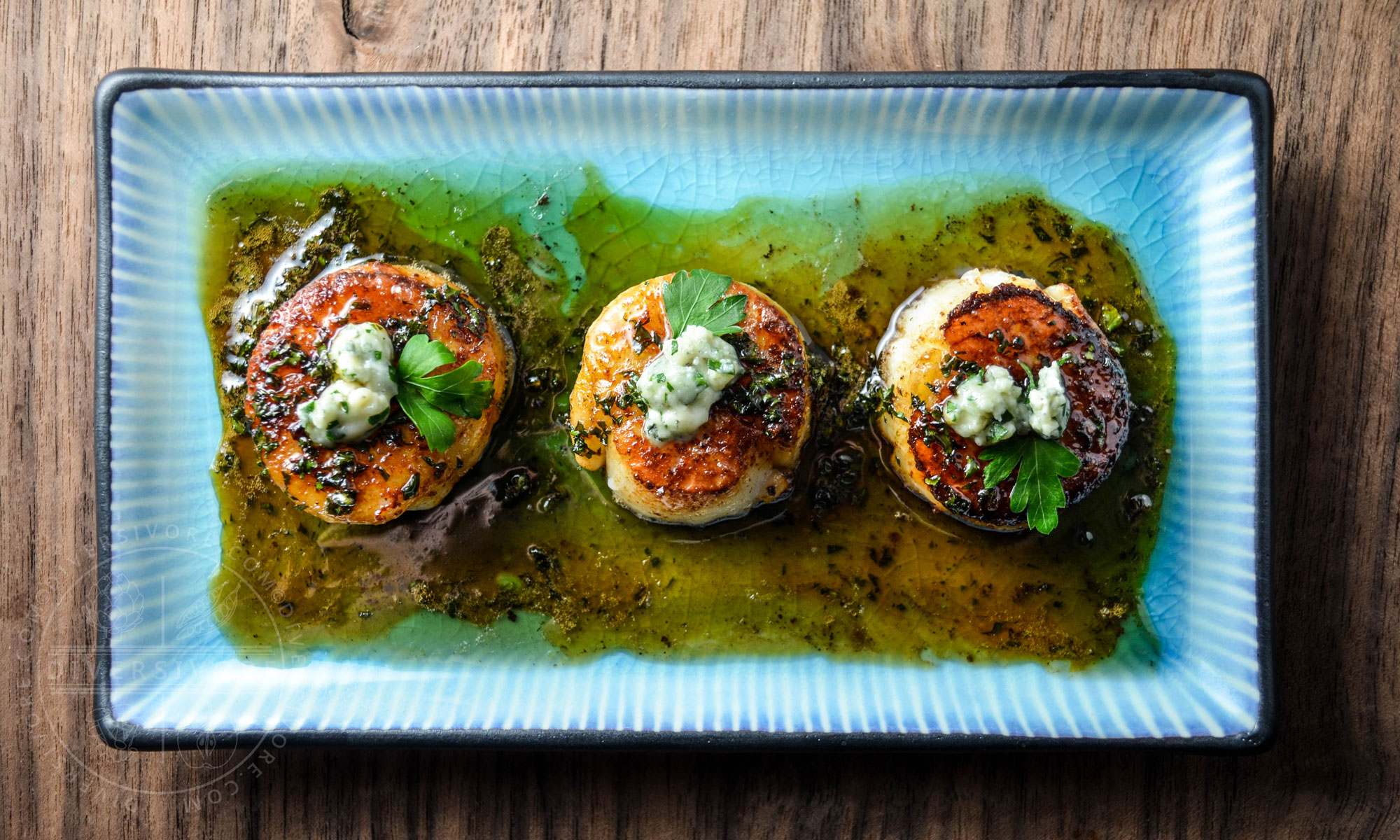Seared scallops with a honey-parsley gastrique and blue cheese