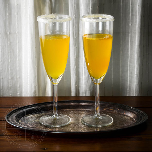 Two sparkling saffron cocktails on a tray