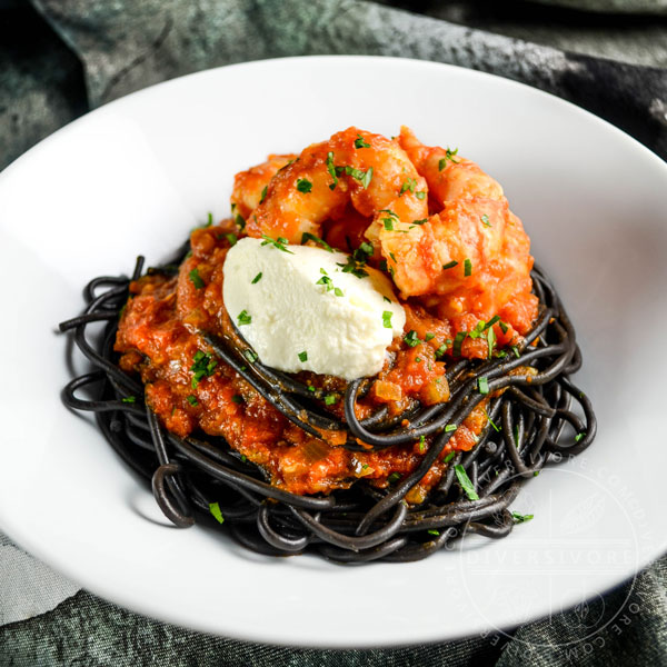 Spot prawns in a saffron tomato sauce with mascarpone cheese and nero di seppia pasta