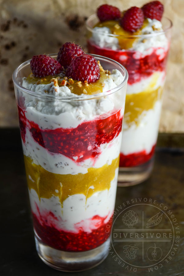 Cranachan with raspberries and greengages in two tall glasses