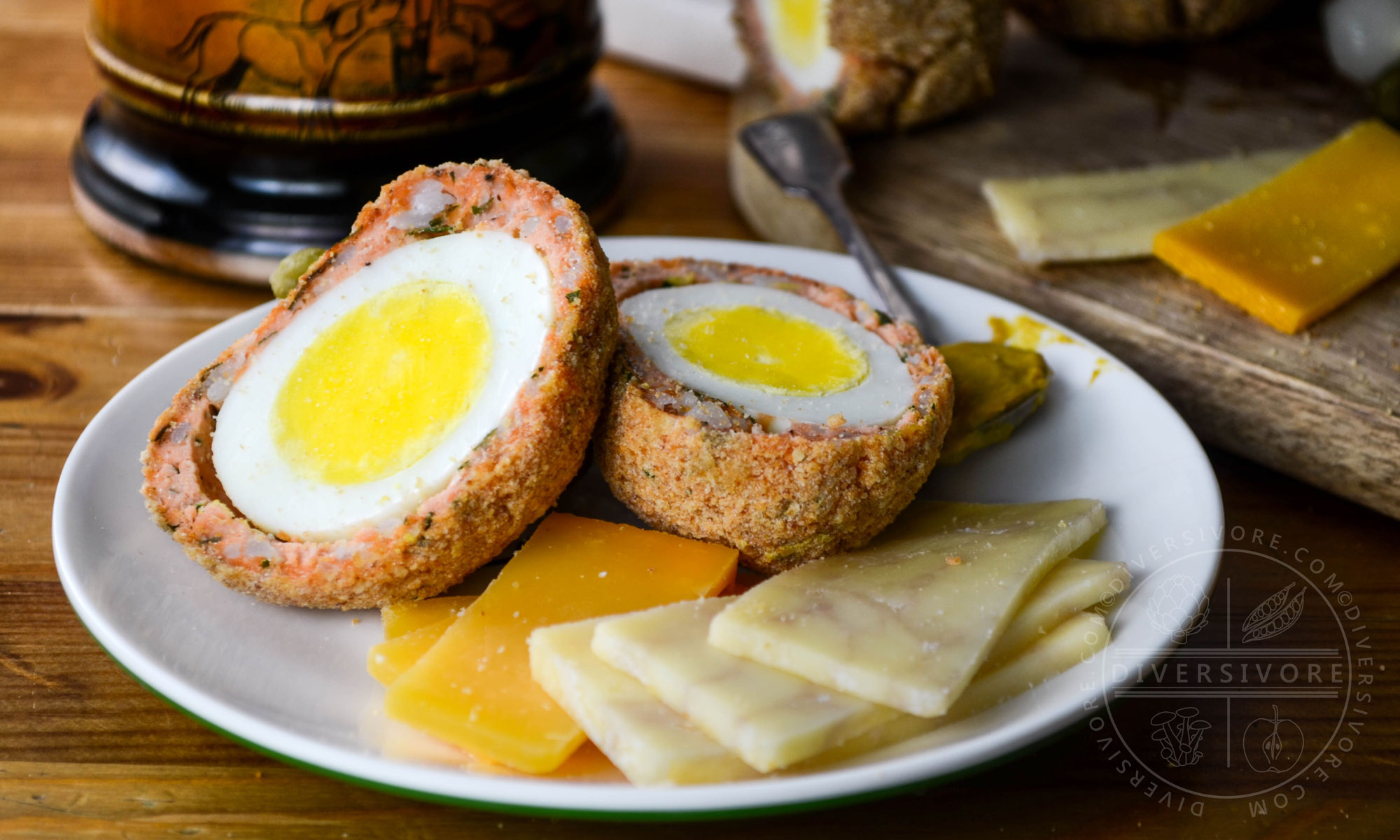 West Coast scotch eggs made with salmon sausage, served with cheese and mustard