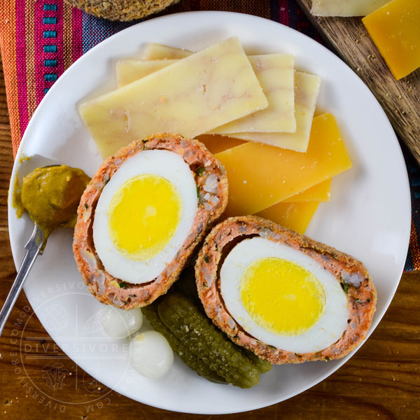 Salmon sausage Scotch eggs with cheese, pickles, and onions