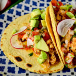 Chicken tinga, served as tacos with pico de gallo, avocados and cheese - Diversivore.com