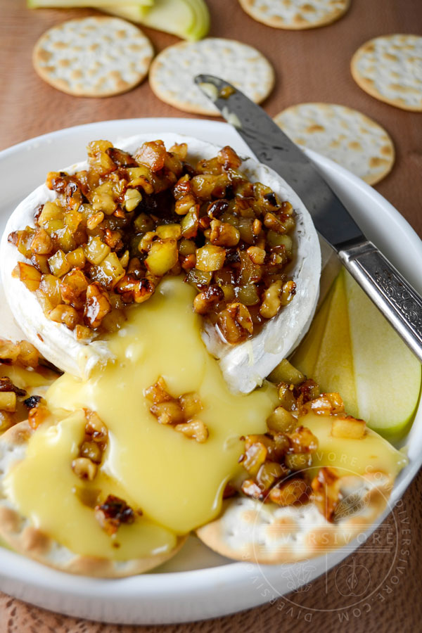 Oozing baked brie, topped with an apple, walnut, and caraway mixture, served with crackers