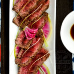 Appetizer portion of beef tataki with ponzu, watermelon radishes, and scallions - Diversivore.com