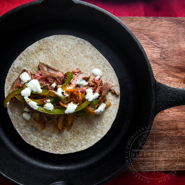 Carne Asada Borracha (Mexican beer-marinated grilled steak) served with Mexican crema and sauteed vegetables, served in a flour tortilla