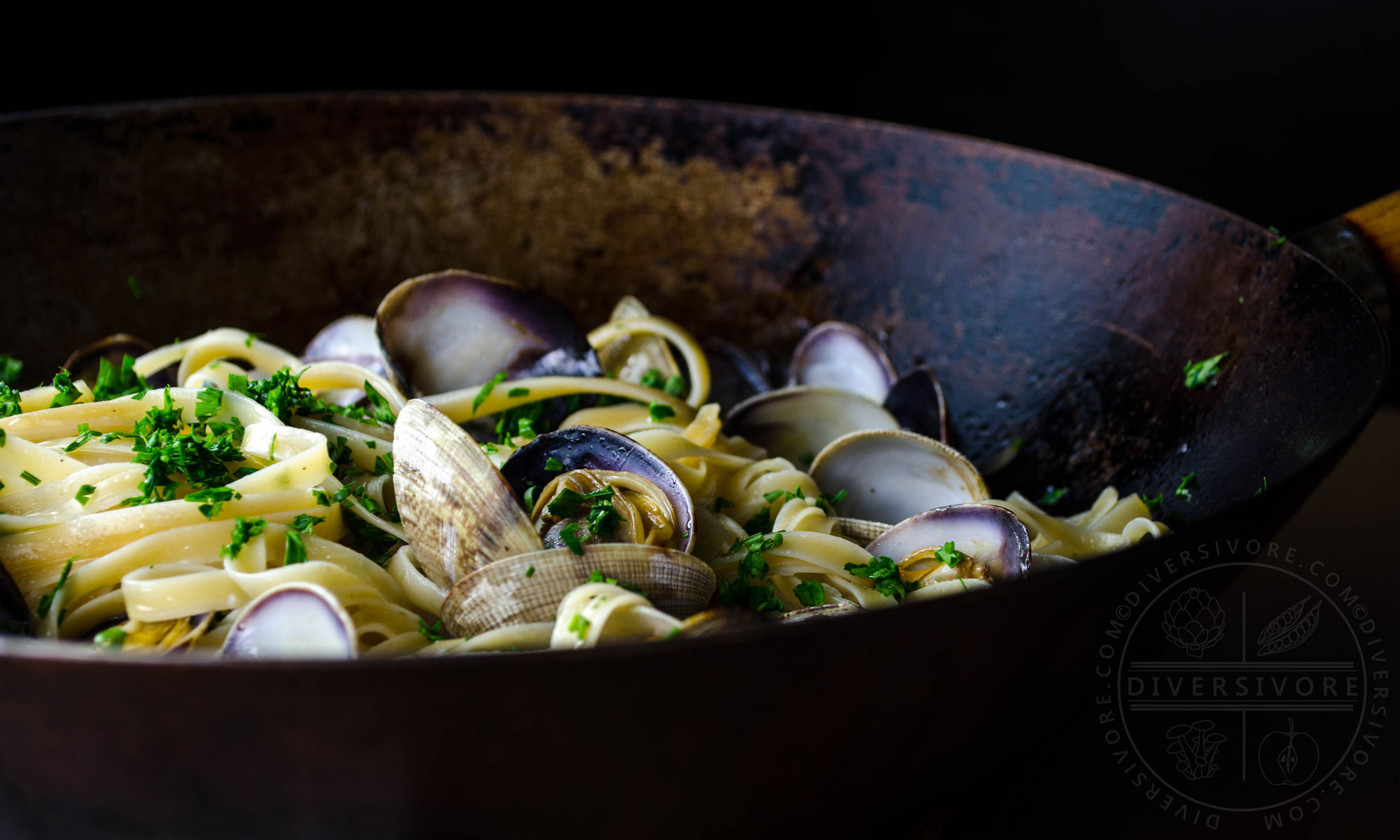 Pasta alle vongole (with white wine, olive oil, and clams) in a large wok