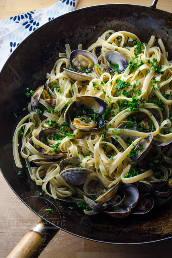 Pasta alle vongole (with white wine, olive oil, and clams) in a large wok