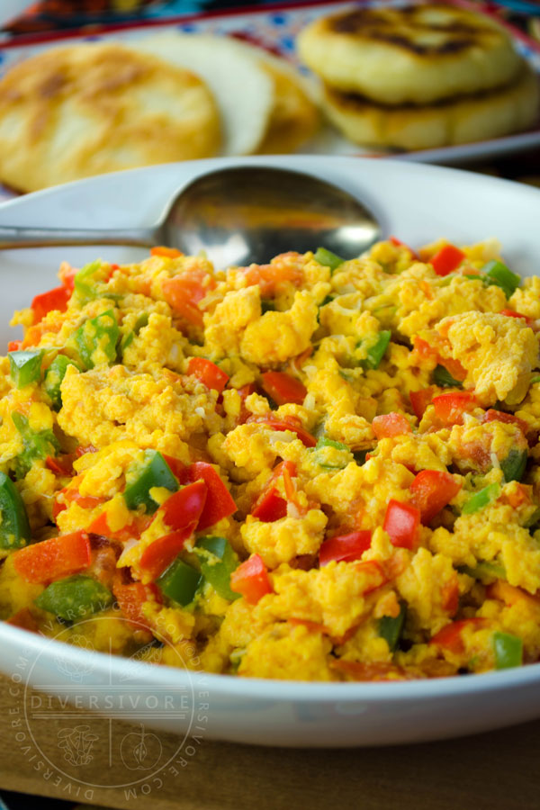 Perico - Colombian/Venezuelan scrambled eggs with peppers, tomatoes, and onions, served in a shallow white bowl