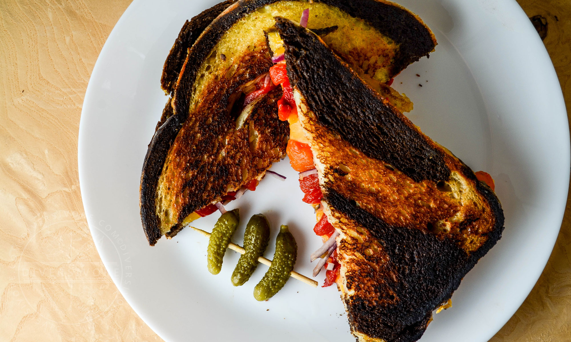Pickled Pepper Grilled Cheese on marble rye with cornichons