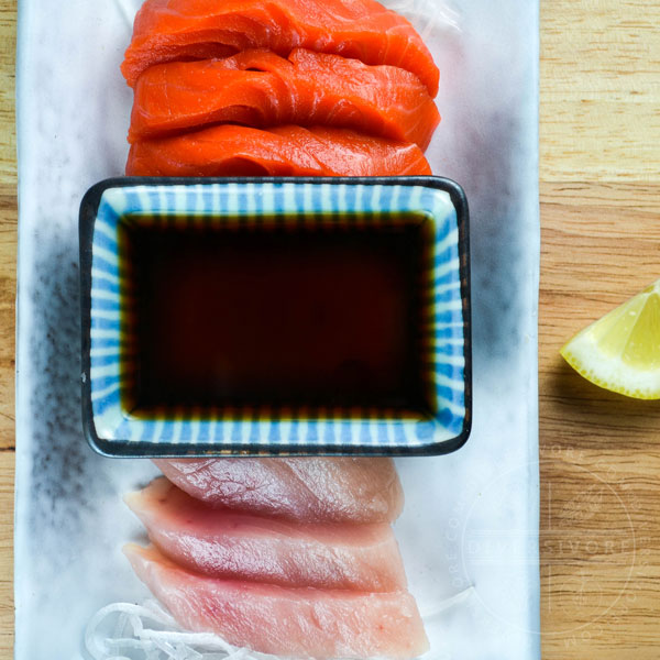 Ponzu shoyu with sashimi and a lemon wedge