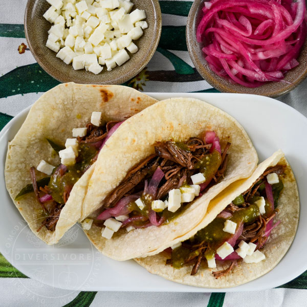 Brisket with pasilla-morita adobo, served in three tacos on a platter