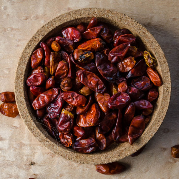 Pequin chilies in a small cork dish