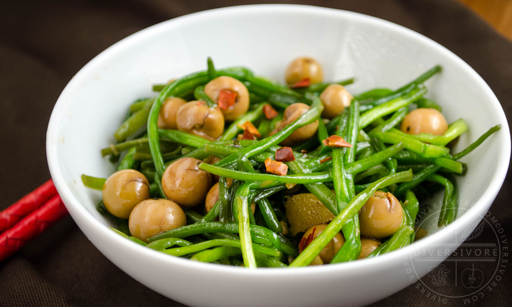 Stir-fried white water snowflake stems with po buzi (fragrant manjack), served in a white bowl