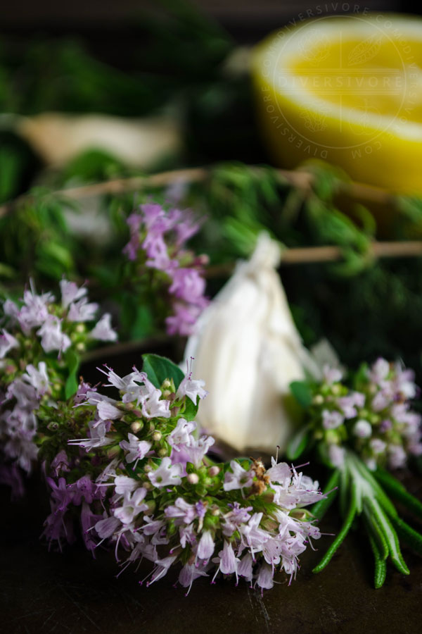 Various fresh herbs, garlic, and lemon