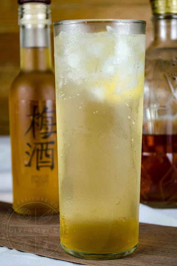 Ume Highball - a Whisky & Umeshu cocktail with ginger, shown in a tall highball glass with whiskey and umeshu bottles