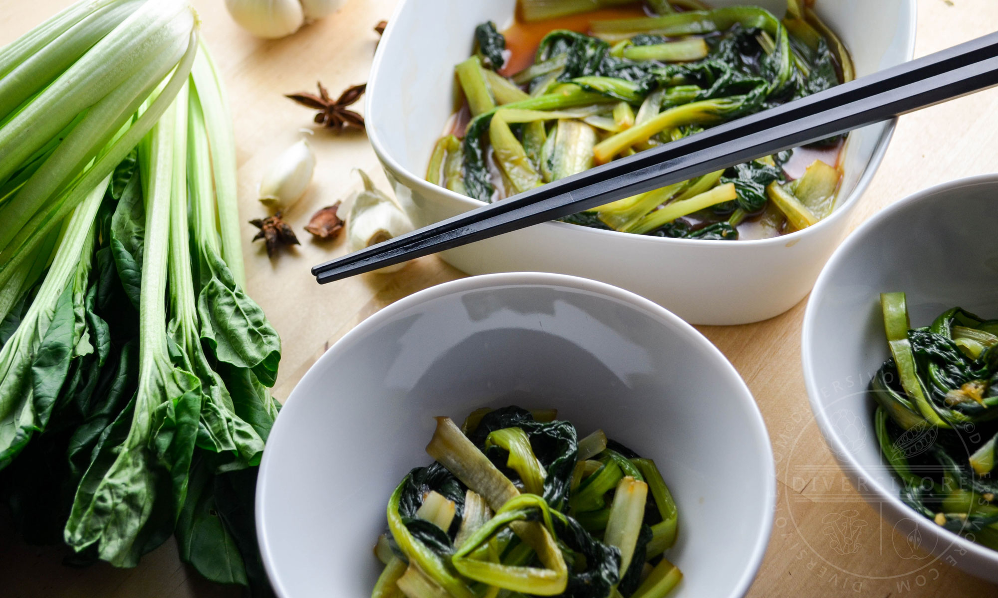 Braised tatsoi (rosette bok choy) in bowls with chopsticks