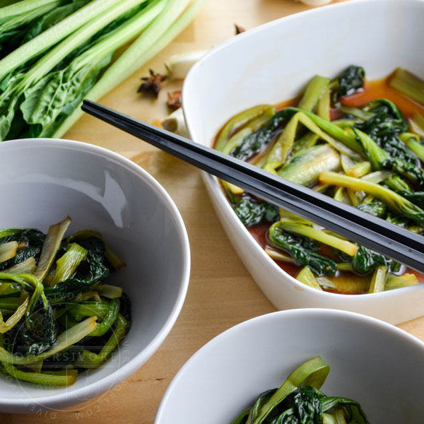 Braised tatsoi (rosette bok choy) in bowls with chopsticks
